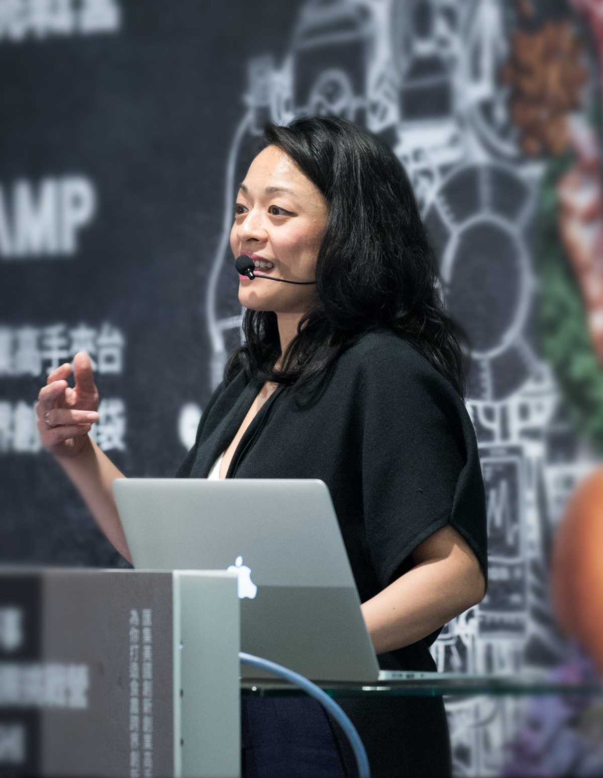 Val Madamba presenting on stage
