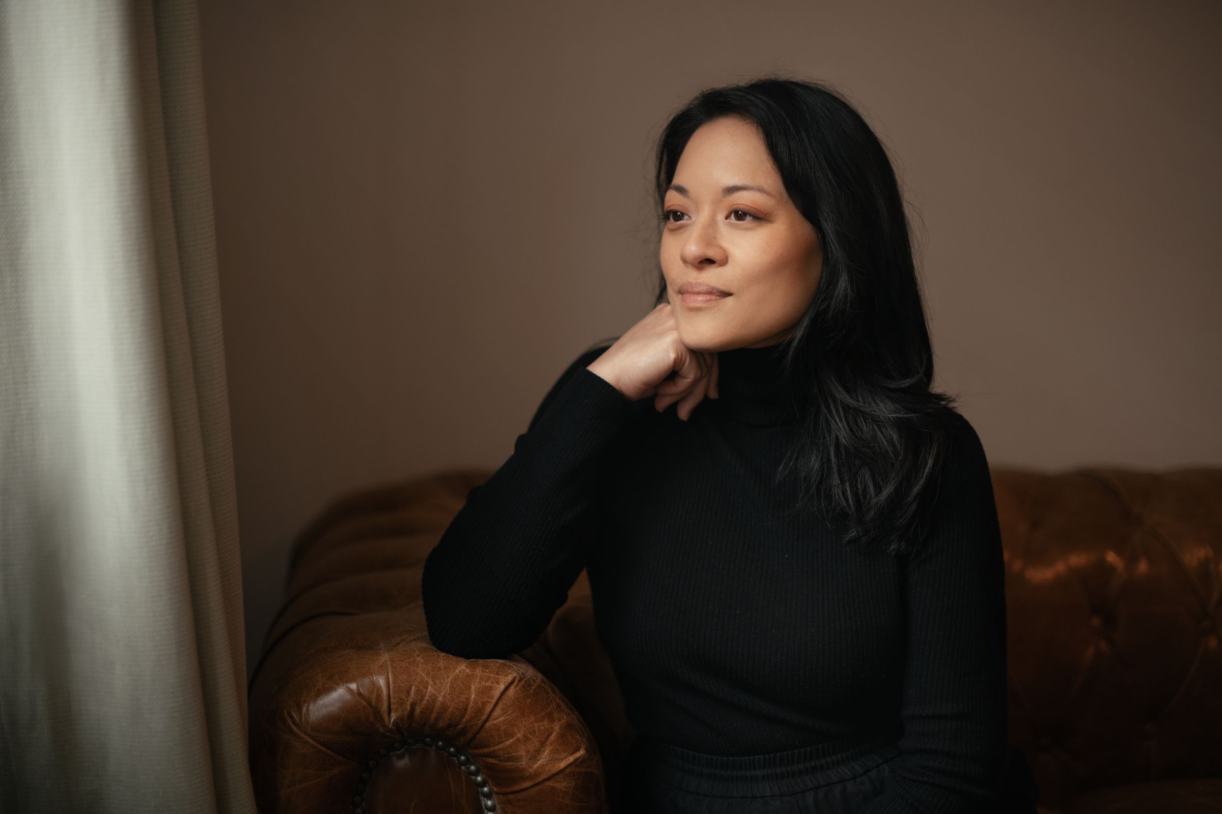 Val Madamba seated in a leather armchair